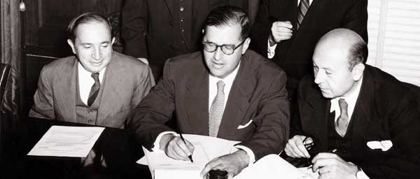 Abba Eban, Israeli Ambassador to the U.S., signs the agreement between the Claims Conference and Israel on September 10, 1952-the same day as the signing of the Luxembourg Agreements.