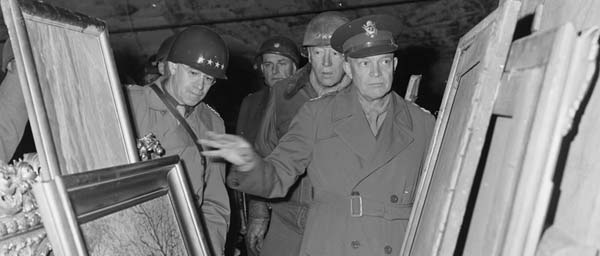 General Dwight D. Eisenhower inspects art treasures looted by the Germans and stored away in the salt mine at Merkers, Germany. (photo-National Archives)