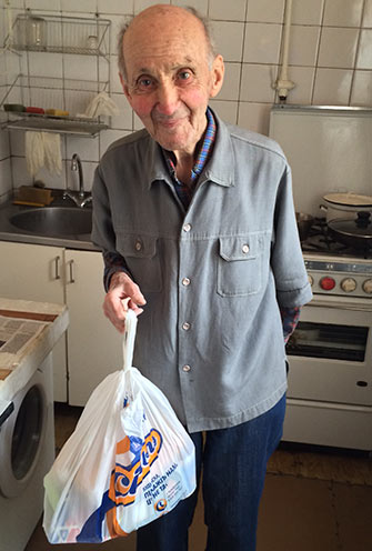 Mihail, a Holocaust victim in Kiev who receives aid funded by the Claims Conference, was grateful and relieved to receive food brought to him by the American Jewish Joint Distribution Committee (JDC), which works with the local Hesed social service agency.