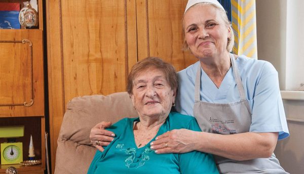 Survivor poses for photo with home health aide