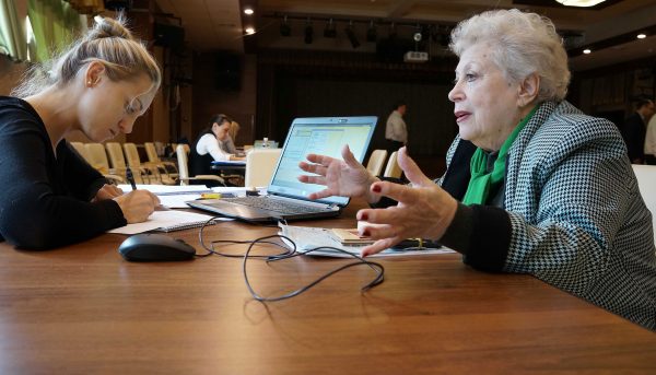 A caseworker helps a survivor with her claim.