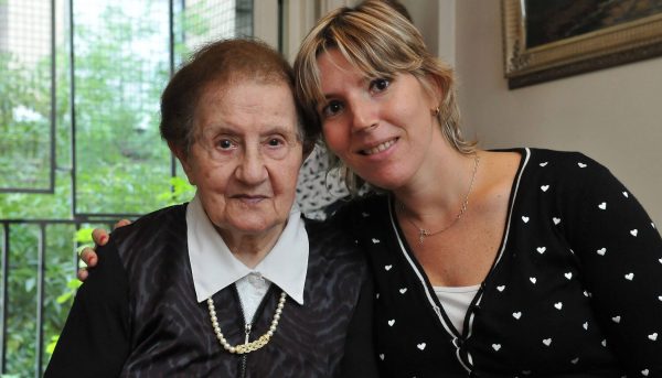 A Holocaust survivor with her caseworker. 